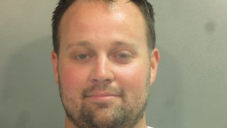 Reality star Josh Duggar poses for his mugshot