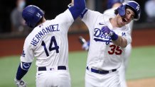 ARLINGTON, TEXAS - OCTOBER 18: Cody Bellinger #35 of the Los Angeles Dodgers is congratulated by Enrique Hernandez #14 after hitting a solo home run against the Atlanta Braves during the seventh inning in Game Seven of the National League Championship Series at Globe Life Field on October 18, 2020 in Arlington, Texas. (Photo by Tom Pennington/Getty Images)