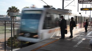 Passenger wait to board a train.