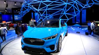 People visit Ford’s all-electric SUV Mustang Mach-E at the 2019 Los Angeles Auto Show in Los Angeles, the United States, Nov. 22, 2019.