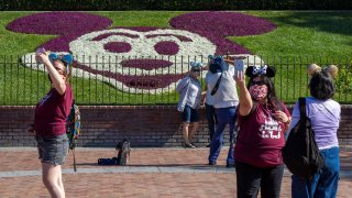 People enter Disneyland Park as it reopens for the first time since the COVID 19 pandemic forced the park to shut down last year on April 30, 2021 in Anaheim, California.