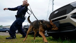 Virginia State Police K-9 officer Tyler Fridley, works his dog Aries at State Police headquarters in Richmond, Va.
