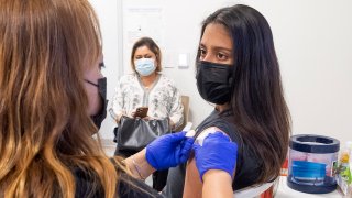 ANAHEIM, CA – APRIL 28: A 16-year-old gets instructions after getting her Pfizer-BioNTech COVID-19 vaccine from an RN at UCI Health Family Health Center in Anaheim, CA on Wednesday, April 28, 2021 as her mom watches. UCI Health and the Anaheim Union High School District are partnering to provide COVID-19 shots to students ages 16+ and their families. (Photo by Paul Bersebach/MediaNews Group/Orange County Register via Getty Images)