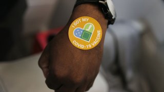 MIAMI, FLORIDA – MAY 17: Alex Telfort receives a sticker after getting a Pfizer-BioNTech COVID-19 vaccine at the UHealth’s pediatric mobile clinic on May 17, 2021 in Miami, Florida. The University of Miami Health System’s pediatric mobile unit began distributing COVID-19 vaccines in Miami-Dade’s underserved communities to ages 12 and above. (Photo by Joe Raedle/Getty Images)