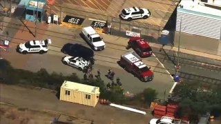 Authorities work at the scene of a mass shooting at a VTA rail yard in San Jose.