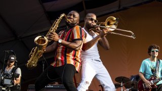 Trombone Shorty, center right, of Trombone Shorty & Orleans Avenue, performs at the New Orleans Jazz and Heritage Festival on Sunday, May 5, 2019, in New Orleans.