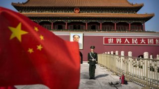 A Chinese soldier stands guard in front of Tiananmen Gate outside the Forbidden City in Beijing.
