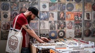 A visitor is seen looking for records during the XXVII International Record Fair.