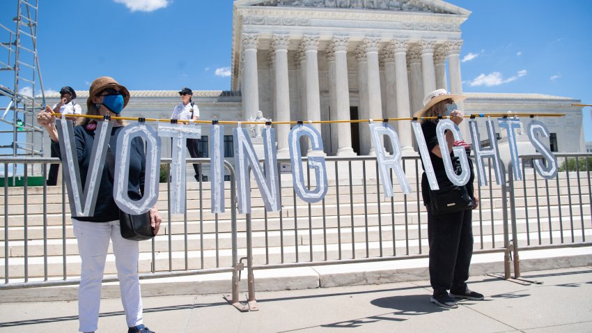 Demonstrators call for Senators, specifically US Senator Joe Manchin, Democrat of West Virginia, to support the elimination of the Senate filibuster in order to pass voting rights legislation and economic relief bills, as they protest during the “Moral March” outside the US Supreme Court on Capitol Hill in Washington, DC, June 23, 2021.