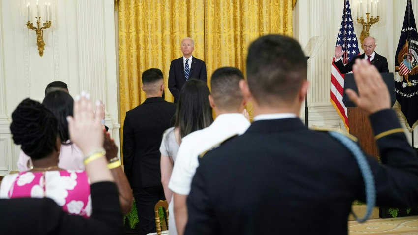 US President Joe Biden watches as people take the Oath of allegiance during a naturalization ceremony for new citizens ahead of Independence Day in the East Room of the White House in Washington, DC on July 2, 2021.