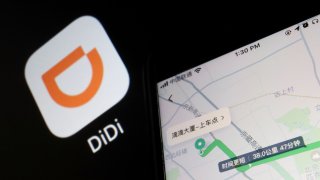 A navigation map on the app of Chinese ride-hailing giant Didi is seen on a mobile phone in front of the app logo displayed in this illustration picture taken July 1, 2021.
