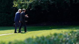 President Joe Biden, left, walks back to the Oval Office with National Security Adviser Jake Sullivan, right, at the White House