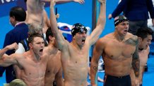 Caeleb Dressel, of United States, right, and teammates celebrate winning the gold medal in the men's 4x100-meter medley relay final at the 2020 Summer Olympics, Sunday, Aug. 1, 2021, in Tokyo, Japan.