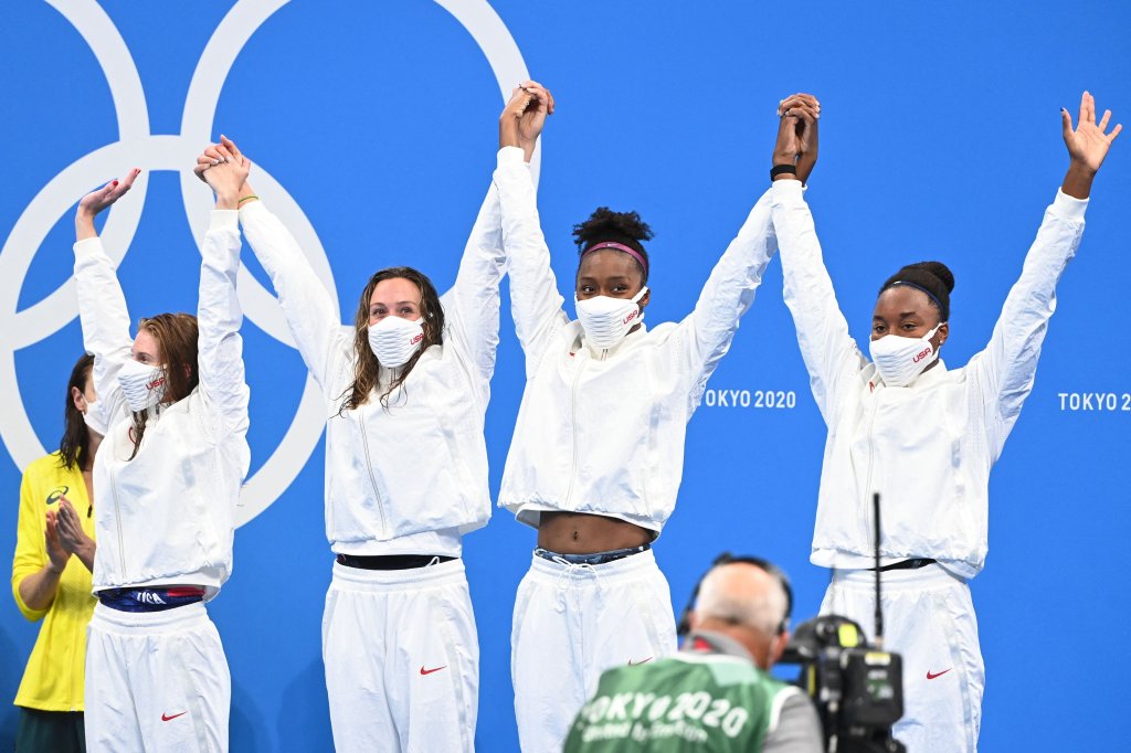 Bronze medallists (from L) USA's Erika Brown, USA's Abbey Weitzeil, USA's Natalie Hinds and USA's Simone Manuel pose on the podium after the final of the women's 4x100m freestyle relay swimming event during the Tokyo 2020 Olympic Games at the Tokyo Aquatics Centre in Tokyo on July 25, 2021.