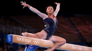 Suni Lee competes on the uneven bars