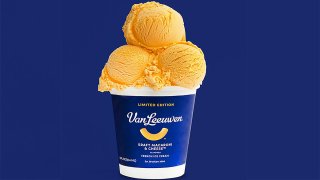 A tub of Kraft Macaroni & Cheese ice cream with three scoops on top.