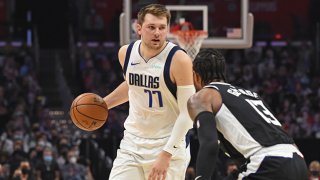 FILE: Luka Doncic #77 of the Dallas Mavericks handles the ball against Paul George #13 of the LA Clippers during Round 1, Game 7 of the 2021 NBA Playoffs on June 6, 2021 at STAPLES Center in Los Angeles, California.
