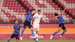 Chris Wood of New Zealand competes for a header with Takehiro Tomiyasu of Japan