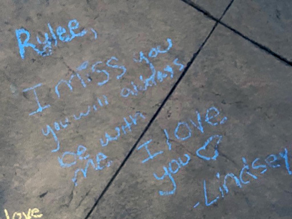 Messages in honor of Rylee Goodrich, 19, and Anthony Barajas, 18, were left outside a movie theater at The Crossings mall in Corona.