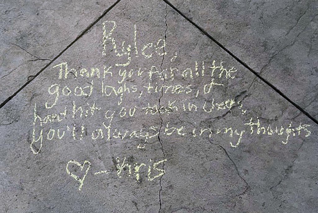 Messages in honor of Rylee Goodrich, 19, and Anthony Barajas, 18, were left outside a movie theater at The Crossings mall in Corona.