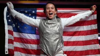 Lee Kiefer celebrates winning a gold medal in women's individual foil 
