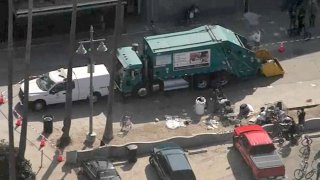 Sanitation crews are pictured at a Venice Boardwalk homeless encampment.