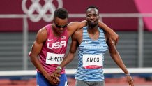 Isaiah Jewett, of the United States, and Nijel Amos, right, of Botswana, shake hands after falling in the men's 800-meter semifinal at the 2020 Summer Olympics, Sunday, Aug. 1, 2021, in Tokyo.