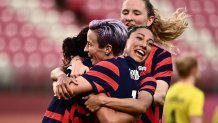 USA's forward Carli Lloyd, left, is congratulated by teammates after scoring during the Tokyo 2020 Olympic Games women's bronze medal football match between Australia and the United States at Ibaraki Kashima Stadium in Kashima city, Ibaraki prefecture on Aug. 5, 2021.