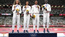 Gold medalists Allyson Felix, Athing Mu, Dalilah Muhammad and Sydney McLaughlin of Team United States stand on the podium during the medal ceremony for the Women's 4x400m Relay on day fifteen of the Tokyo 2020 Olympic Games at Olympic Stadium on Aug. 7, 2021 in Tokyo, Japan.