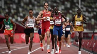 Winner Spain's Mohamed Katir (L) speaks with second-placed USA's Paul Chelimo after competing in the men's 5000m heats during the Tokyo 2020 Olympic Games