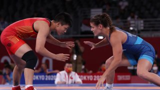 Team USA's Kayla Miracle in blue wrestles China's Long Jia in Tokyo