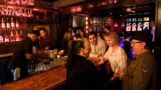 Fully vaccinated customers gather at the bar inside Risky Business, in the North Hollywood neighborhood of Los Angeles, California on May 21, 2021.