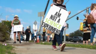 Anti-vaccine protesters stage a protest outside of the San Diego Unified School District office to protest a forced vaccination mandate for students on September 28, 2021 in San Diego, California.