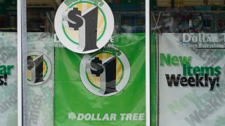 In this Feb. 25, 2021 photo, Dollar Tree store logos indicating that everything in the store is for $1 are promoted on its storefront window in Jackson, Miss.