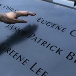 ésirée Bouchat reaches towards the inscribed name of James Patrick Berger at the National September 11 Memorial