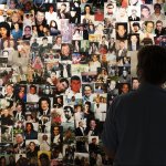 Désirée Bouchat looks at photos of those who perished, in a display at the 9/11 Tribute Museum