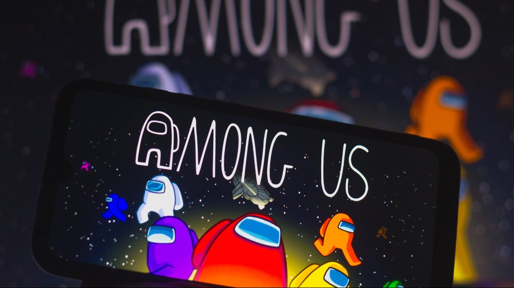 In this photo illustration, the Among Us logo is displayed on a smartphone. Among Us is an online arcade game in the group game and survival genre.