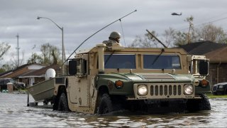 A National Guard vehicle drives through floodwater left behind by Hurricane Ida in LaPlace, Louisiana on Monday, Aug. 30, 2021.