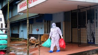 A health official stands outside the Kozhikode Medical College Hospital ward