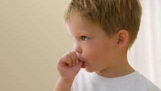 Caucasian boy sucking his thumb