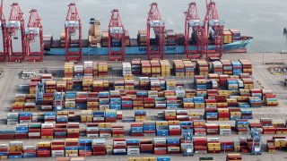 Shipping containers are unloaded from a ship at a container terminal at the Port of Long Beach-Port of Los Angeles complex, amid the coronavirus disease (COVID-19) pandemic, in Los Angeles, California, April 7, 2021.