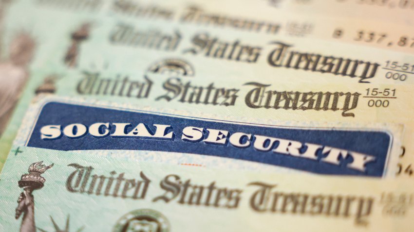 In this photo illustration, a Social Security card sits alongside checks from the U.S. Treasury on October 14, 2021 in Washington, DC.