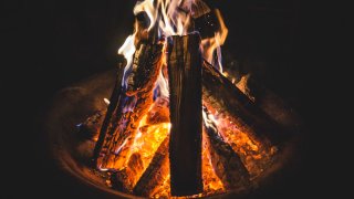 Fire burns in a fire pit.