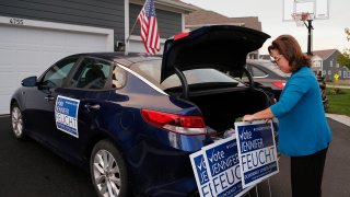 Jennifer Feucht, candidate for Olentangy Local Board of Education, delivers campaign flyers and yard signs