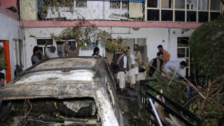 FILE - In this Sunday, Aug. 29, 2021 file photo, Afghans inspect damage of Ahmadi family house after U.S. drone strike in Kabul, Afghanistan. The Pentagon retreated from its defense of a drone strike that killed multiple civilians in Afghanistan last month, announcing Friday, Sept. 17, that a review revealed that only civilians were killed in the attack, not an Islamic State extremist as first believed.