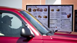 Customer views a digital menu at the drive-thru outside of McDonald's