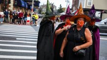 SALEM, MA - OCTOBER 24: A group of witches wait to cross the street while hanging out on Essex Street in Salem, MA on Oct. 24, 2020. Salem Mayor Kim Driscoll and Governor Charlie Baker on Wednesday implored the public to avoid the historic city between now and Halloween and said there will be early businesses closings, significant parking restrictions, and no traditional holiday events this weekend and next in an effort to thin out crowds amid the ongoing COVID-19 pandemic. (Photo by Erin Clark/The Boston Globe via Getty Images)