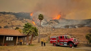 A Cal Fire engine company provides structure protection to a ranch.