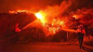 Firefighters knock down flames during the Alisal Fire near Santa Barbara.