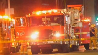 A Los Angeles County Fire Department fire engine at the scene of a house fire.